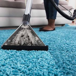 person using an at home carpet cleaner